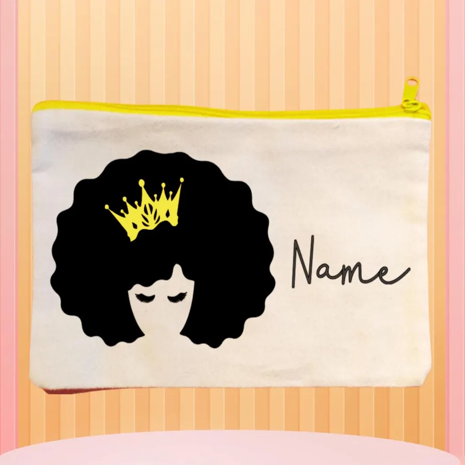 Canvas bag with a graphic of a woman with an afro and eyelashes wearing a gold crown with personalised name text.