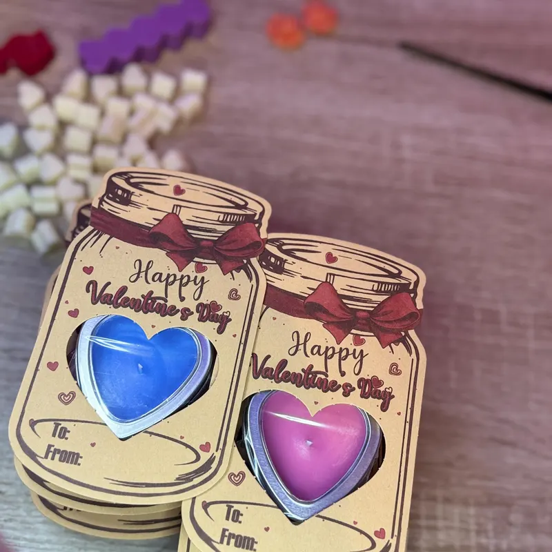 Two valentines heart-shaped candles in cute cardboard packaging stating 'happy valentines day', 'to' and 'from'.