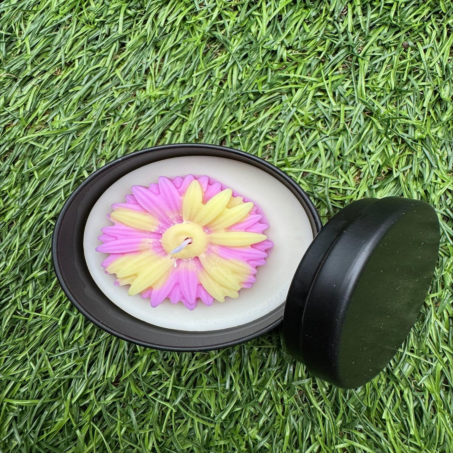 Top view of pink and yellow flower-Shaped candle.